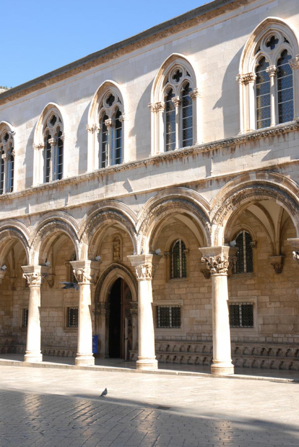 Gothic arcade and arched windows on the facade of the Rector's Palace in Dubrovnik
